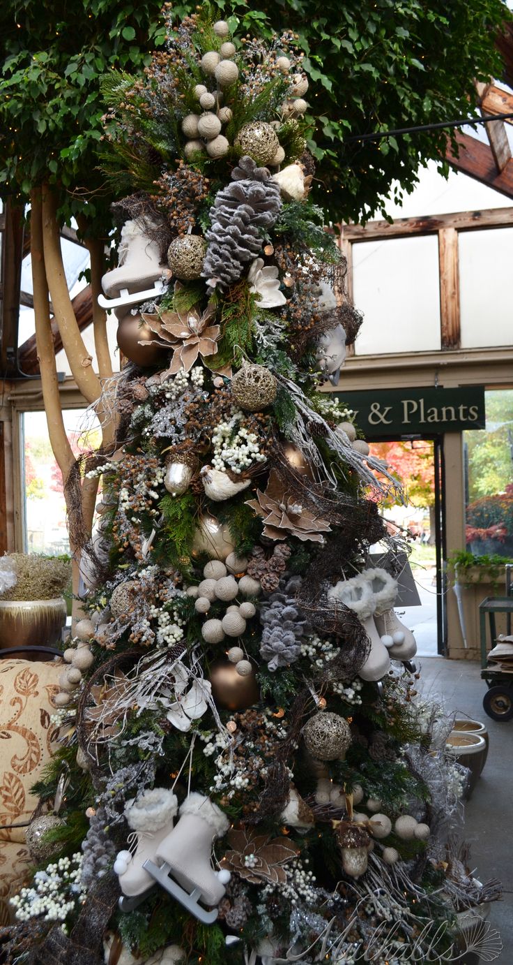 a christmas tree decorated with ornaments and greenery