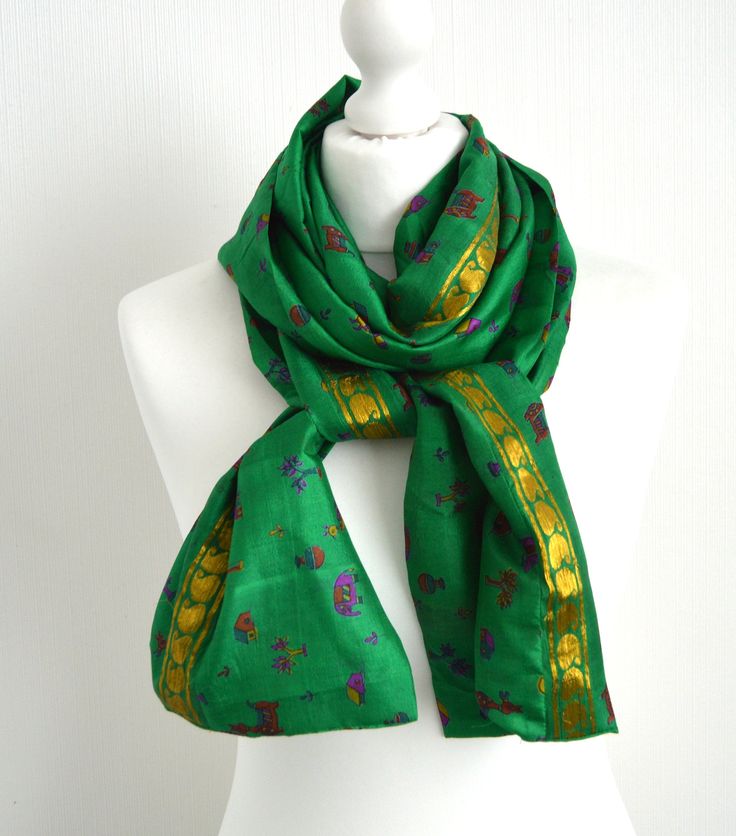 "This scarf has been sewn from a vintage 100% silk sari to make a lovely, simple to wear accessory: just wrap it twice or three times around your neck, or fold in half & slip one end through the other - a versatile accessory of generous proportions. The natural, breathable silk means it will keep you warm in the winter but won't be too hot for the summer. This scarf is available in three styles; a standard straight rectangular scarf, an infinity or loop scarf where the ends are sewn together Bohemian Silk Scarf For Festivals, Bohemian Green Art Silk Dupatta, Traditional Green Scarves For Festive Season, Vintage Silk Dupatta For Festive Occasions, Festive Vintage Silk Dupatta, Traditional Green Handloom Scarves, Traditional Green Handloom Scarf, Festive Silk Scarves With Traditional Patterns, Green Bohemian Dupatta With Zari Weaving