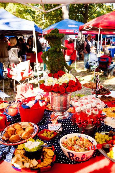 a table filled with lots of food under umbrellas