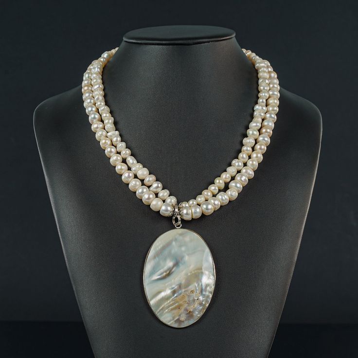 This 2 strand fresh water white Pearl (5x10mm) Necklace is 21" plus the 2x3" oval Mother of Pearl Pendant with the Sterling frame and circular Sterling 16mm toggle. The Pendant is removable if you decide you want to wear it as a basic Pearl Necklace. Go to www.darajanejewellery.com to see rings, earrings and bracelets and a large crystal collection. Pearl White Oval Necklace With Pearl Drop, Pearl White Oval Beads Jewelry Gift, Pearl White Oval Beads Jewelry For Gift, White Pearl Drop Oval Necklace, White Oval Pearl Pendant Necklace, Single Strand Oval Pearl Necklace For Gift, White Oval Pearl Drop Necklace, Oval Single Strand Pearl Necklace As A Gift, Oval Silver Pearl Necklace