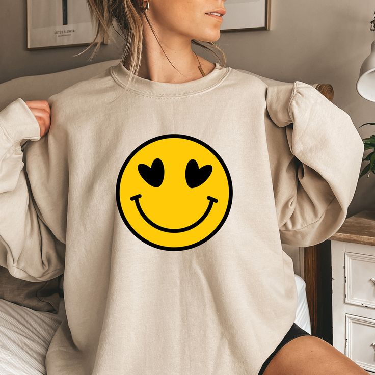 "Smiley Faces Sweatshirts, Cute Smiley Face Sweater, Smiling Emoji Tee, Positive Vibes,Happy Face, Retro Smiley Face Shirt,Emoji Face Shirts Welcome to the different, crazy and colorful world of ORANGE WORLD :) PRODUCT DETAILS Collar, shoulders, armholes, cuffs and hem double-needle stitched  -  1 x 1 rib with spandex Features a crewneck -  Relaxed fit - Unisex -  50% cotton 50% polyester HOW TO ORDER 1- Please review all photos, 2- Choose your size and color from the drop-down menus, 3- Click t Trendy Long Sleeve Tops With Smiley Face, Fun Crew Neck Top With Smiley Face, Fun Smiley Face Crew Neck Top, Playful Crew Neck Top With Smiley Face, Playful Smiley Face Crew Neck Top, Cute Long Sleeve Smiley Face Top, Funny Smiley Face Crew Neck Tops, Relaxed Fit Smiley Face Crew Neck Top, Smiley Face Sweater