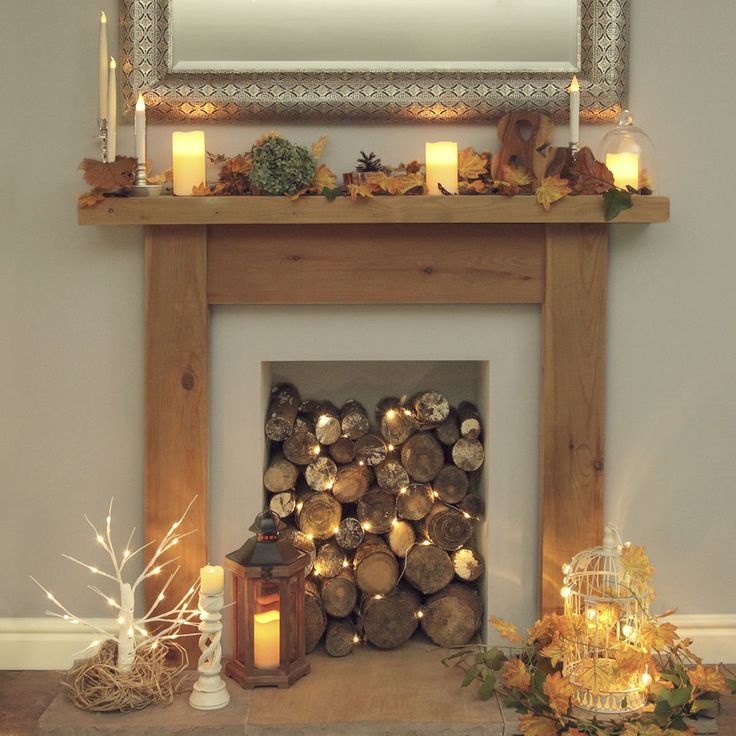 a fireplace with candles and decorations around it