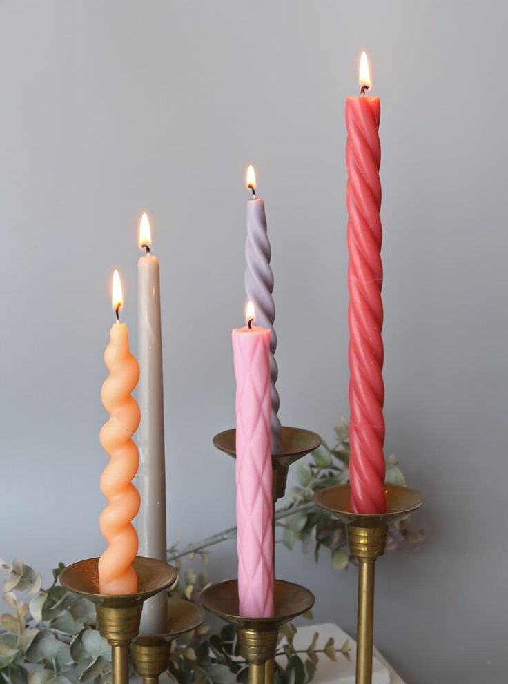 three candles with different colors and sizes on them