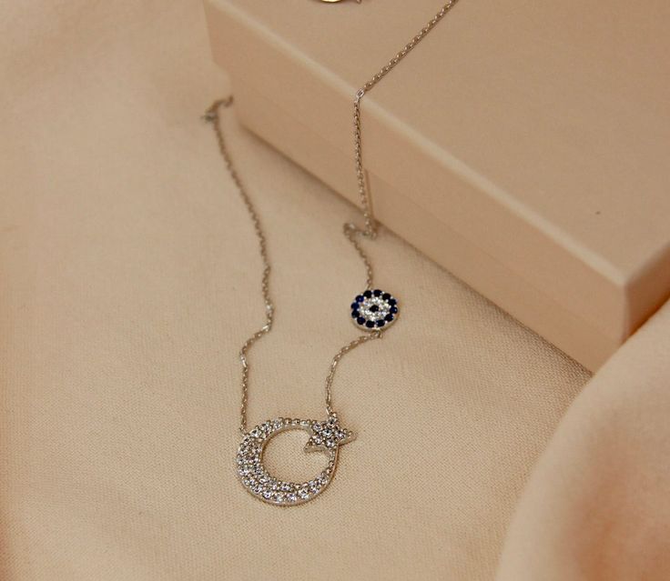 Silver Star and Crescent Necklace   ✔Handmade silver moon and star&evil eye necklace ✔925 sterling silver ✔Preserves its shine for a long time ✔Ready for shipping Necklace  Material: 925 Sterling Silver Gemstone: Zircon Stone Width: 1.40 cm-0.55 in. Height: 1.10 cm-0.43 in. Weight: 1.88 gr You may choose it as a gift.🤍 If you have a question please don't hesitate to contact me.  YOU MAY USE THE EXPRESS SHIPPING OPTION TO GET YOUR ORDER FASTER. Express shipping send by UPS, TNT, and FedEx. Delivery time:  *Europe 2-4 business days, *USA- Canada 3-7 business days, *Everywhere else 5-10 business days. **Please share your phone number with me in case of cargo returns. Feel free to view my other accessories; https://www.etsy.com/shop/aliveaccessories Thank you for visiting my shop! Sterling Silver Moon Necklace Fine Jewelry, Sterling Silver Moon Necklace In Fine Jewelry Style, Silver Crescent Necklace Fine Jewelry, Silver Crescent Necklace In Fine Jewelry Style, Silver Celestial Jewelry For Her, Silver Crescent Fine Jewelry Necklace, Silver Celestial Jewelry As A Gift For Her, Silver Crescent Jewelry With Cubic Zirconia, Silver Crescent Cubic Zirconia Jewelry