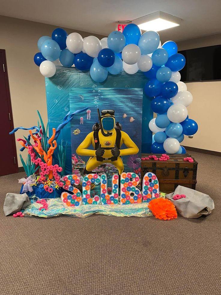 a birthday party with balloons and decorations on the floor, including an under water theme