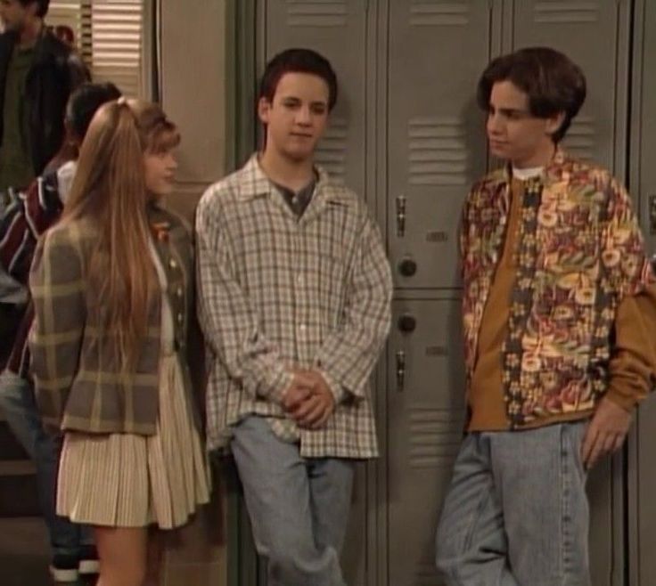 three young people standing next to each other in front of lockers and locker doors