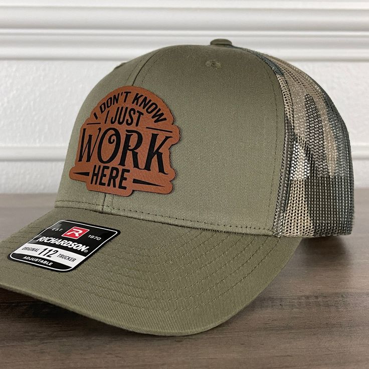 I Don't Know I Just Work Here Funny Leather Patch Hat Green/Camo. Specifications: 🧢 Richardson original 112 trucker; adjustable for the perfect fit 🎩 60/40 cotton/polyester blend for comfort 📏 One size fits most 🏷️ Expertly laser engraved leatherette patch design 📦 Ships in 2 to 3 business days from our Orlando Studio Care Instructions: 🚫 Do not wash; spot clean only Please Note: 🌈 Colors may vary from photos based on your viewing screen. This funny hat is a unique and entertaining gift for fathers, embracing their dual role with humor. Fitted Snapback Hat For Outdoor, Fitted Flat Bill Snapback Hat For Outdoor, Fitted Flat Bill Trucker Hat For Outdoor, Fitted Trucker Hat For Outdoor, Fitted Snapback Hat With Flat Brim For Outdoor, Fitted Flat Brim Snapback Hat For Outdoor, Fitted Flat Bill Baseball Cap For Outdoor, Fitted Flat Brim Baseball Cap For Outdoor, Fitted Flat-brim Baseball Cap For Outdoor