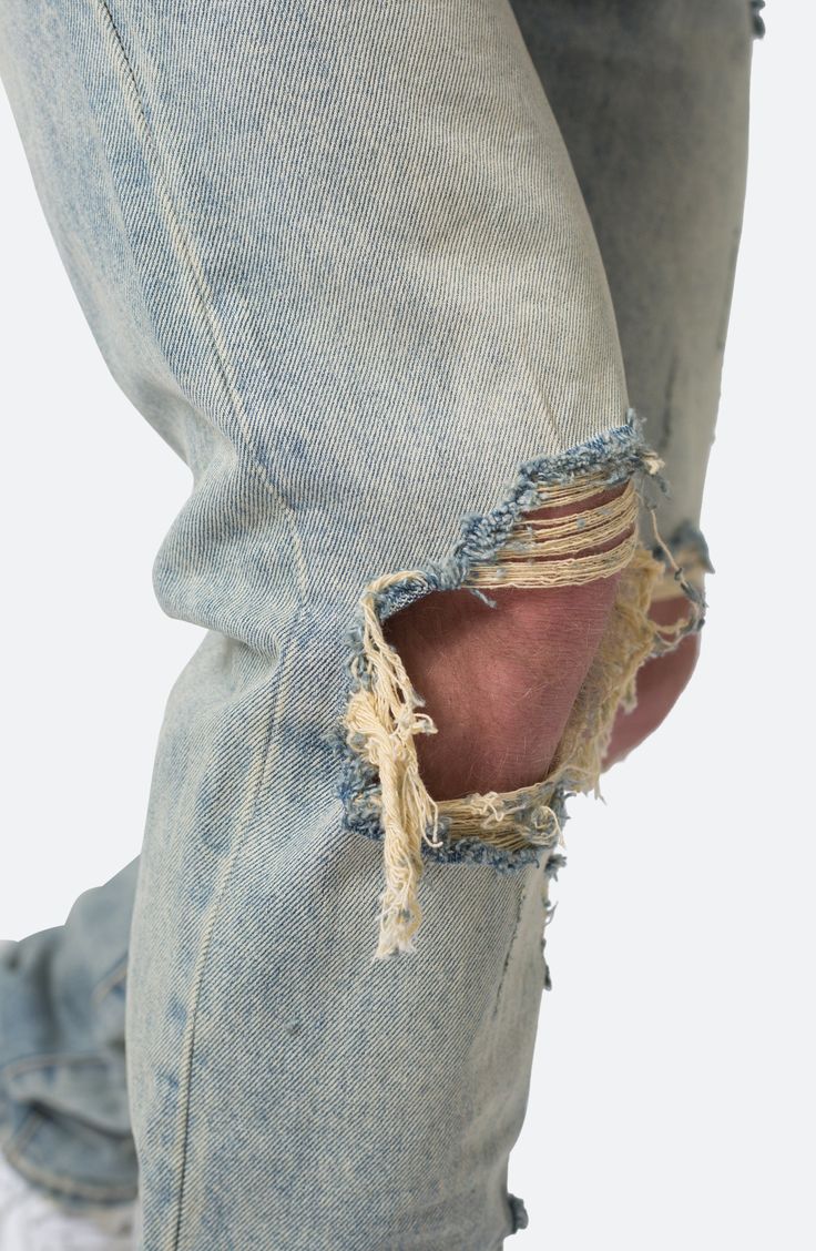 Gaping, threadbare holes bring instant history to jeans cut from well-faded cotton denim with a relaxed fit that stays straight from hips to hems. 34" inseam; 14" leg opening; 10 3/4" front rise Button fly Five-pocket style 100% cotton Machine wash, dry flat Imported