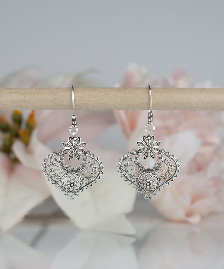 925 Sterling Silver Heart & Flower Earrings Handmade Artisan Crafted Filigree Ornate Dangle Drop Earrings Material: 925 Sterling Silver Earrings Length: 1.75 inches Width: 1 inch Finishing: Oxidized and Polished Comes with a gift pouch and box Free Domestic Shipping Our fine silver jewelry is Made in our exclusive Artisan workshops in Turkey. Our aim is to exceed all the expectations that you have from silver jewelry. Filigree is the art of embroidery with metal thread. It dates back in Turk Stamped Earrings, Silver Heart Earrings, Fine Silver Jewelry, Heart Flower, Gift Pouch, Flower Heart, Sterling Silver Heart, Artisan Craft, 925 Sterling Silver Earrings