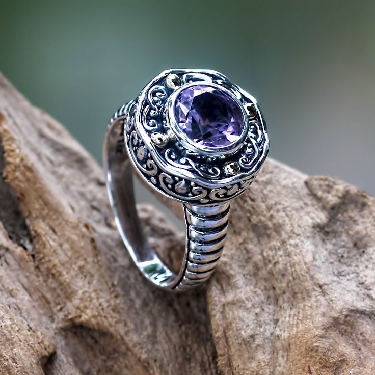 Centered by a sparkling 2-carat amethyst this exquisite ring is designed by Putu Gede Darmawan. His classic Balinese motifs feature details bathed in 18k gold. .925 Sterling silver Elegant Amethyst Crystal Ring With Center Stone, Elegant Amethyst Crystal Ring With Accent Stones, Elegant Amethyst Crystal Ring With Gemstone Accents, Elegant Amethyst Rings With Gemstone Accents, Classic Wedding Amethyst Ring With Gemstone Accents, Classic Amethyst Rings With Gemstone Accents, Elegant Amethyst Crystal Ring Round Cut, Elegant Purple Sapphire Ring With Gemstone Accents, Elegant Ring With Amethyst Center Stone