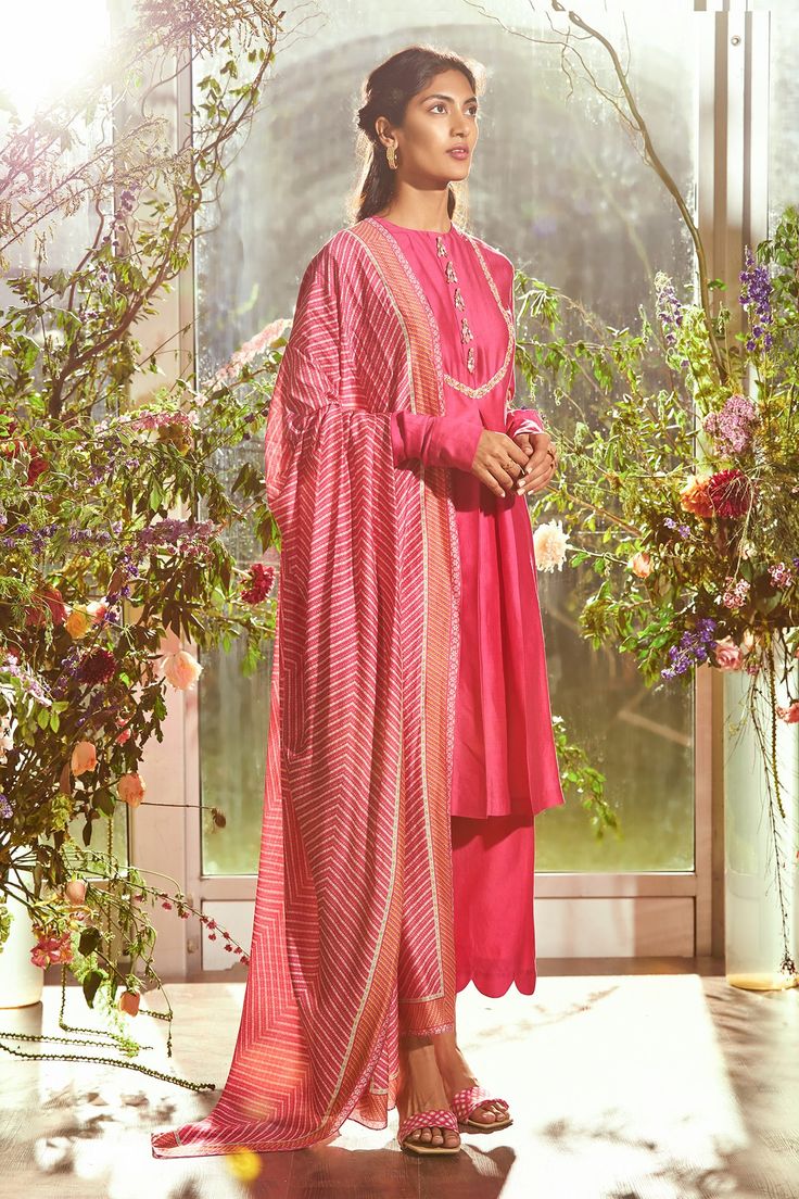 Fuchsia kurta with floral embroidered bodice, sleeves and tassel placket. Paired with scallop hem pant and Bandhani print dupatta.
Component: 3
Embroidered
Neckline: Round
Sleeve Length: Full
Fabric: Chanderi, Fine Silk
Color: Pink
Bandhani print dupatta
Gathered sleeves
Disclaimer: Product colour may slightly vary due to photographic lighting sources and  there can be slight difference in motif print placement due to running print fabric. - Aza Fashions Vani Vats, Punit Balana, Seema Gujral, Ridhi Mehra, Bandhani Print, Anamika Khanna, Kurta Set For Women, Embroidered Bodice, Suits Design