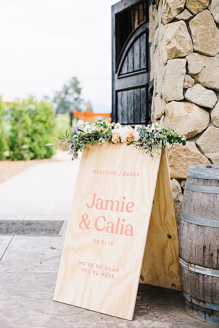 a wooden sign that says welcome to jamie and calia on the side of a building