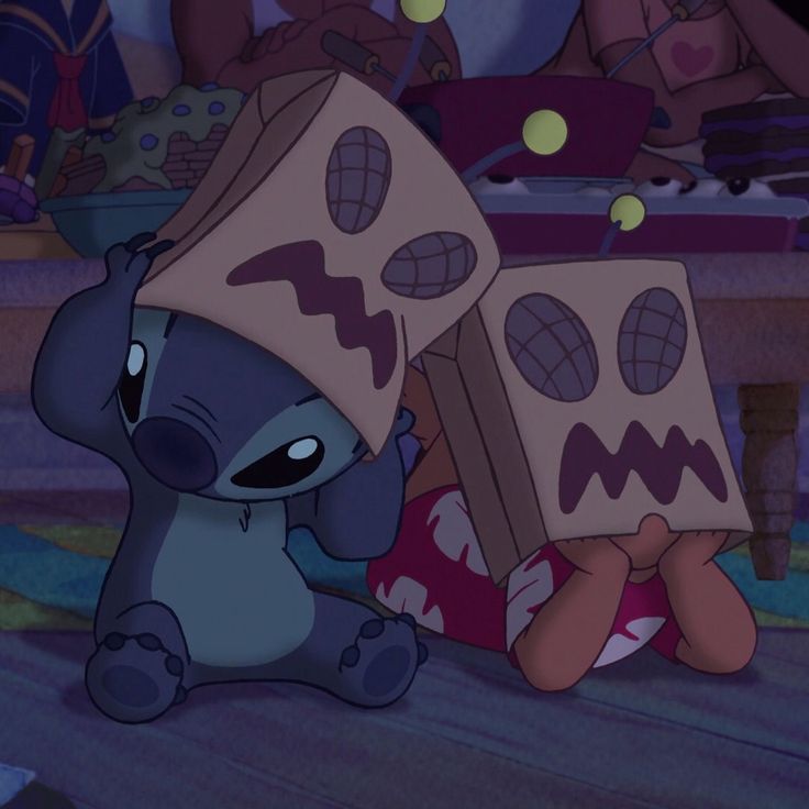 a cartoon character is sitting on the floor with two boxes in front of her head