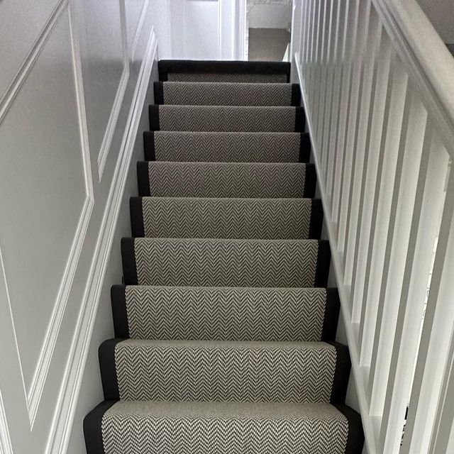 a set of stairs with carpeted treads leading up to the top