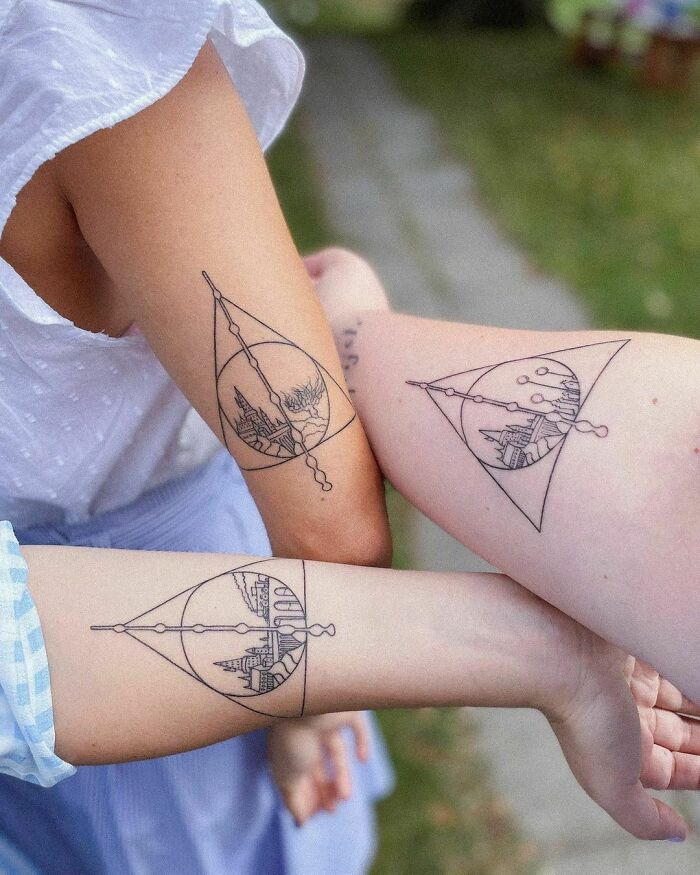 two people with matching tattoos on their arms