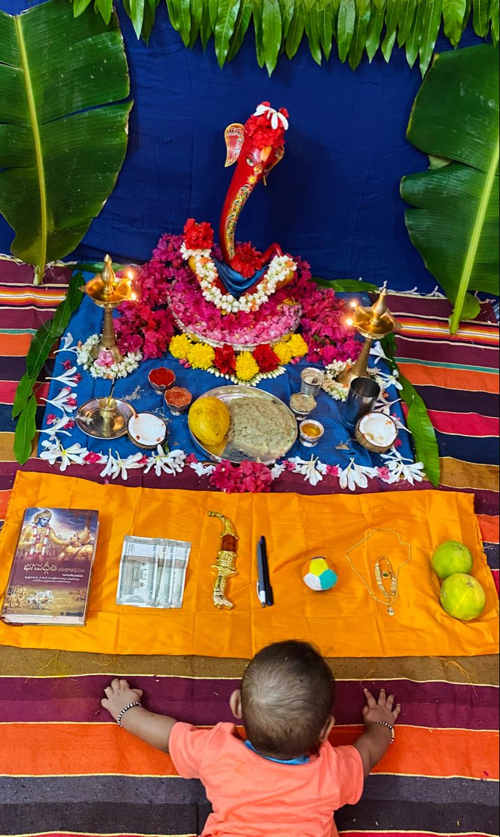 a little boy sitting in front of a table with food and decorations on top of it