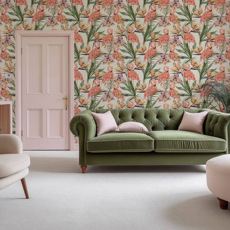 a green couch sitting in front of a pink door and wall with flowers on it