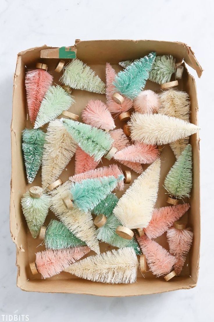 a box filled with assorted pastel colored dusters on top of a white counter