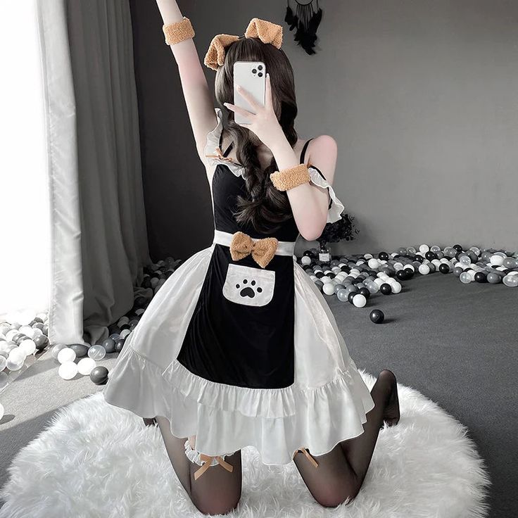 a woman dressed as a cat with her hands up in the air while standing on a fluffy white rug