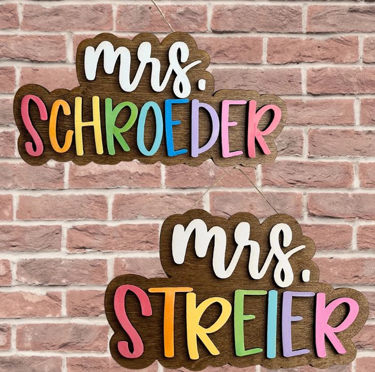 two wooden mr and mrs signs hanging on a brick wall