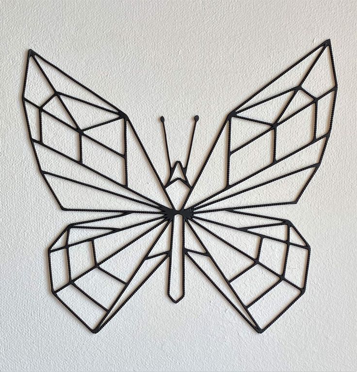 a metal butterfly sculpture on the wall