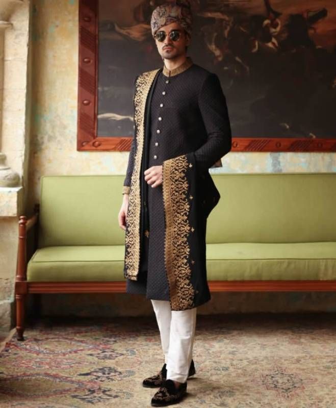 <p><strong>Sherwani:</strong><br />Color: Black<br />Fabric: Jamawar<br />Sherwani features rich quality embellishments accent the on collar and sleeves<br />Fanciful front button closure</p> <p><strong>Inner:</strong><br />Comes with off-white kurta and pajama<br /><br /><strong>Additional Accessories:<br />Tied pre-made Turban: </strong>US$150<strong><br /></strong><strong>Mens Embroidered Shawl (subject to the availablity) As shown: </strong>US$200<strong><br /></strong><strong>Jodhpuri/Salee Designer Embroidered Kurta For Diwali, Designer Embroidered Bandhgala With Straight Kurta, Designer Straight Kurta With Resham Embroidery, Designer Long Sleeve Kurta For Festive Occasions, Festive Traditional Wear With Long Sleeves, Designer Long Sleeve Kurta For Festivals, Designer Long Sleeve Sherwani For Festive Occasion, Designer Resham Embroidery Straight Kurta, Festive Bandhgala With Zari Work In Traditional Fit