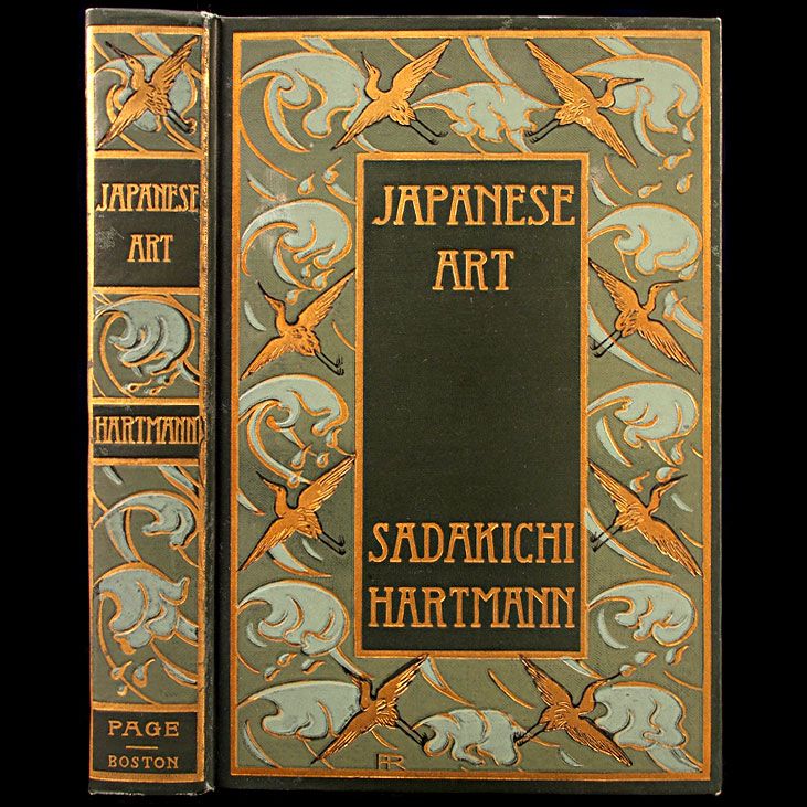 an old book with japanese art written in gold and black on the front cover,