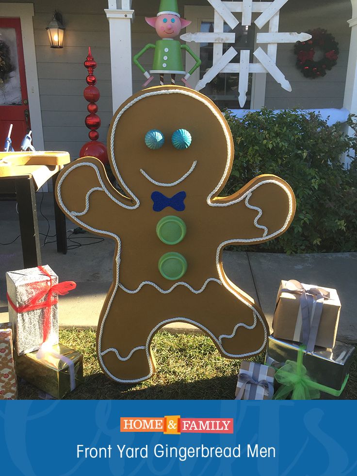 a gingerbread man is standing in front of a house