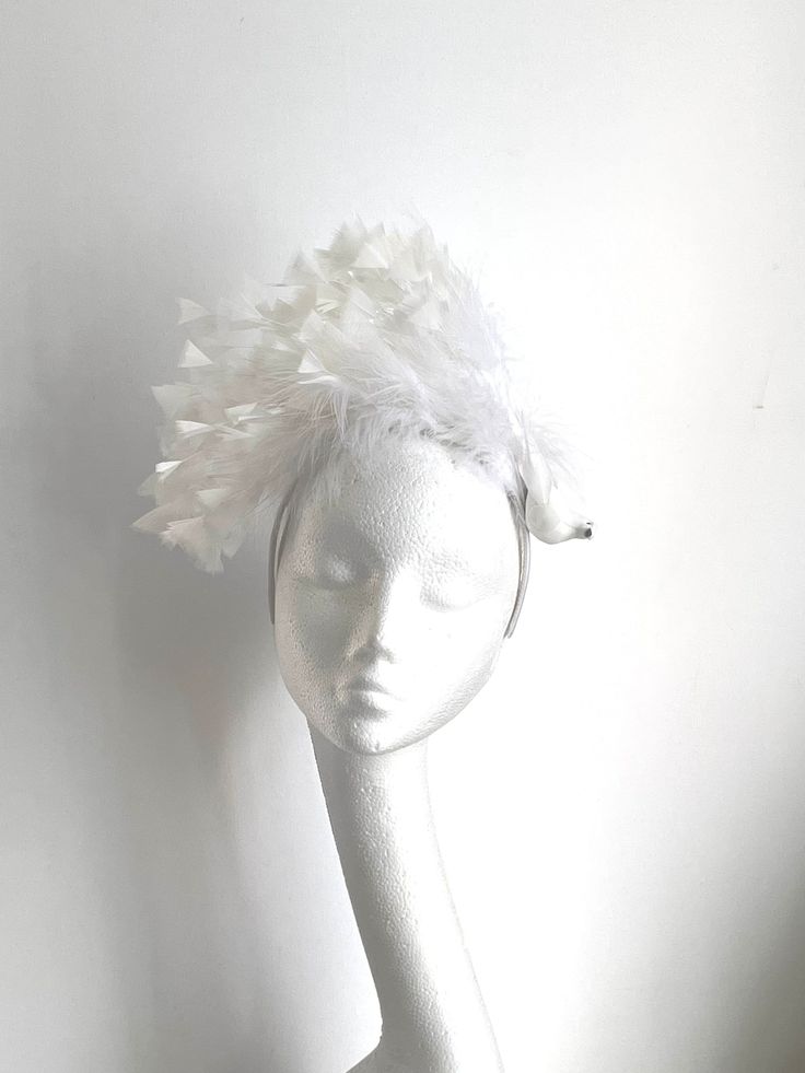 white bird bridal headpiece The white bird bridal headpiece is made from white and off white feathers attached to the white headband. on the side of the headband is off white bird. The white bird bridal headpiece is unique and would be suitable for a bride or a dinner en blanc. Enjoy your special day with this amazing fascinator! Wedding Feather Trim Headband For Royal Ascot, White Headband Fascinator For Party, Wedding Headband With Feather Trim For Royal Ascot, White Headband Mini Hat For Kentucky Derby, White Mini Hat Headband For Kentucky Derby, White Headband Mini Hat For Wedding, White Feathered Fascinator For Formal Occasions, White Feather Fascinator For Formal Events, White Feather Trim Party Hat