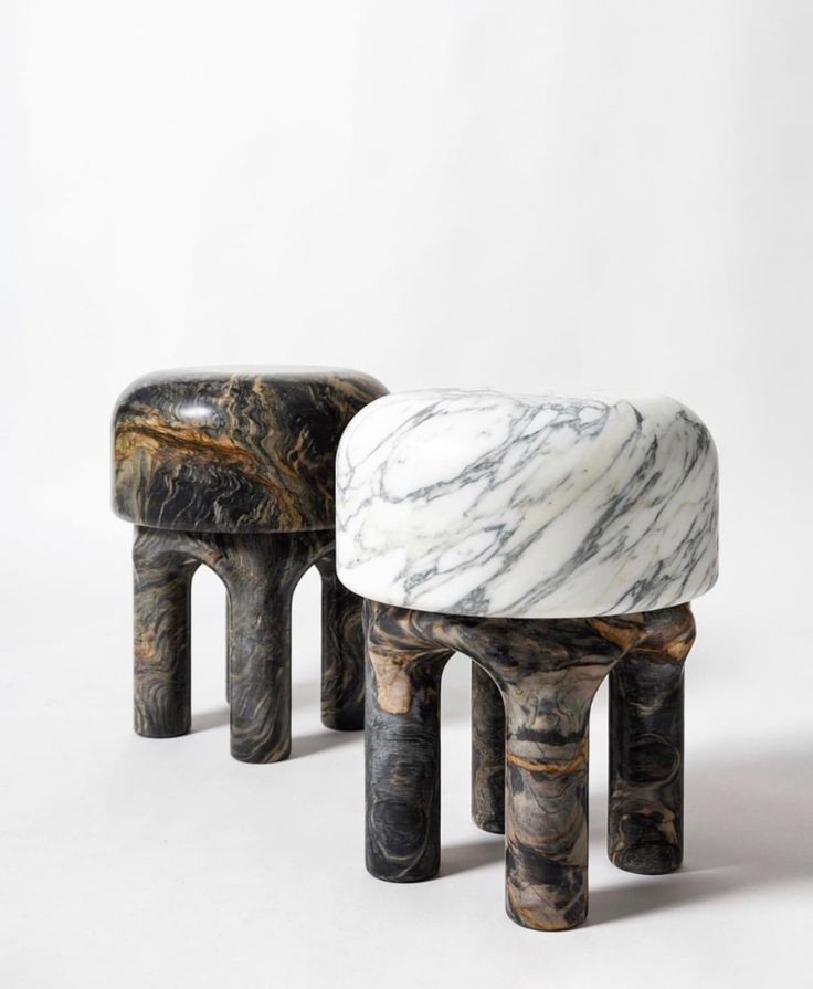 two marble stools sitting next to each other