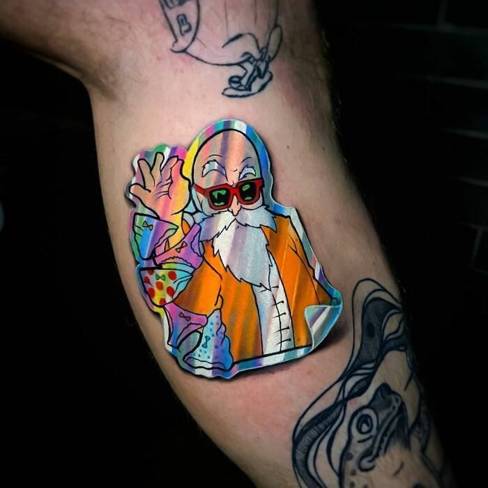 a man's arm with a colorful sticker on it