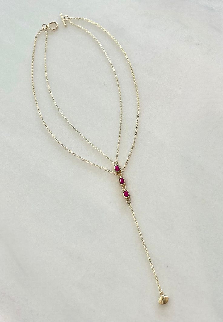 Exquisitely crafted, our Tiered Ruby Lariat Drop necklace embodies classic elegance with a modern flair. Two delicate gold-filled chains adorned with three radiant CZ ruby connectors cascade from a rope style toggle clasp finished with a stunning drop to create a timeless piece that whispers luxury. Size: 16 inches with a 5 inch tiered drop Stacked Necklaces, Bold Jewelry, Toggle Clasp, Chain Ring, Drop Necklace, Gold Filled Chain, Classic Elegance, Gold Filled Jewelry, Sales Gifts