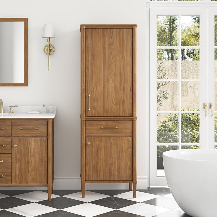 a white bath tub sitting next to a wooden cabinet