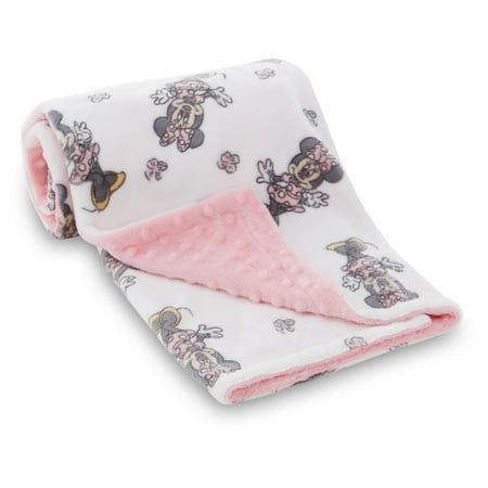 a pink and white blanket with mickey mouse on it