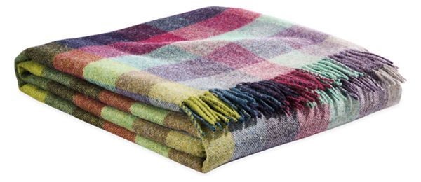 multicolored plaid blanket folded on top of each other