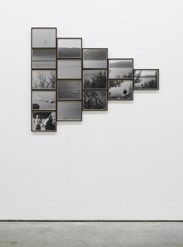 a white wall with several pictures hanging on it