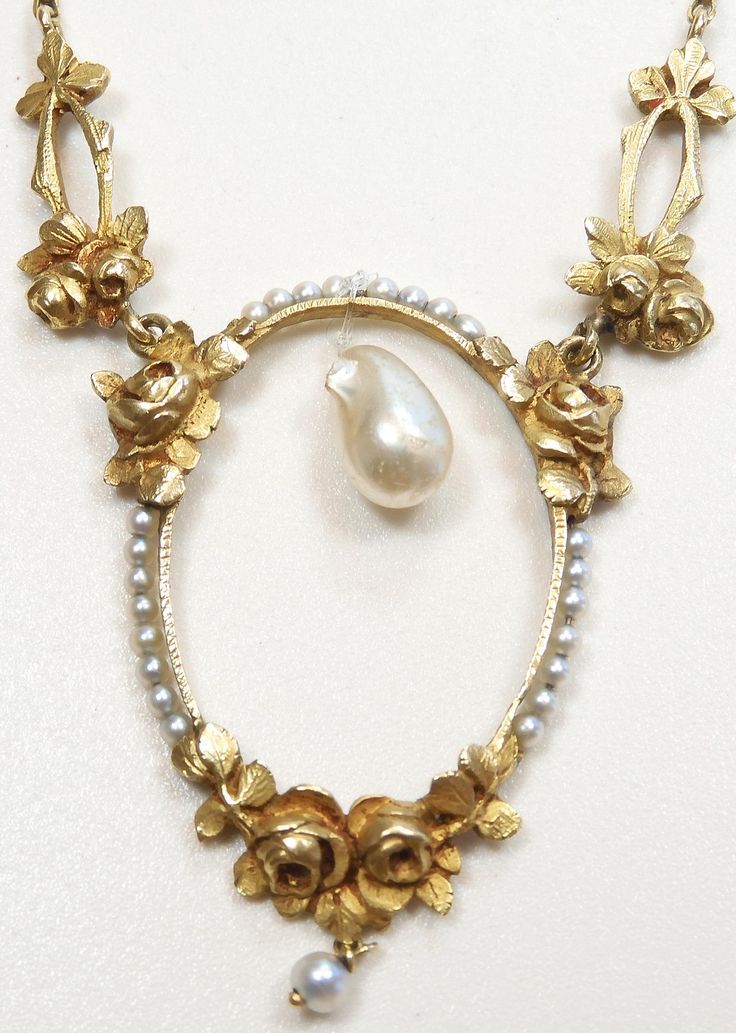 ANTIQUE ART NOUVEAU FRESHWATER AND NATURAL PEARL LAVALIER NECKLACE {International Buyers Are Responsible For Customs & Duty Fees} Circa ~ 1900'S ~ Freshwater Pearl ~  Measurements ~ 8.95 MM - 0.352 Inches x 5.71 MM - 0.2245 Inches x 5.34 MM - 0.210 Inches Color ~ White 23 ~ Round Natural Pearls Color ~ White/Light Grey Size ~ 1.64 MM - 0.064 Inches 1 ~ Round Natural Pearl  Color ~ White/Light Grey Size ~ 3.00 MM - 0.118 Inches Measurement Of Oval Section (North To South) ~ 3892 MM - 1.532 Inches (East To West) Width ~ 27.13 MM - 1.068 Inches Measurement Of Each Gold Floral Link ~ 18.64 MM - 0.734 Inches x 7.89 MM - 0.3105 Inches Thickness Of Oval Floral Section ~ 3.06 MM - 0.1205 Inches Length Of Necklace ~ 17 Inches Thickness Of Chain ~ 1.13 MM - 0.0445 Inches Metal ~ 18K Yellow Solid Gol Antique Pearl Pendant Necklace For Formal Occasions, Baroque Necklaces With Historical Design For Wedding, Elegant Baroque Necklace With Historical Design, Baroque Necklace With Historical Design For Weddings, Elegant Yellow Gold Jewelry With Historical Design, Victorian Hallmarked Jewelry For Opera, Baroque Wedding Necklace With Historical Design, Baroque Historical Design Necklace For Wedding, Antique Yellow Gold Necklace With Historical Design