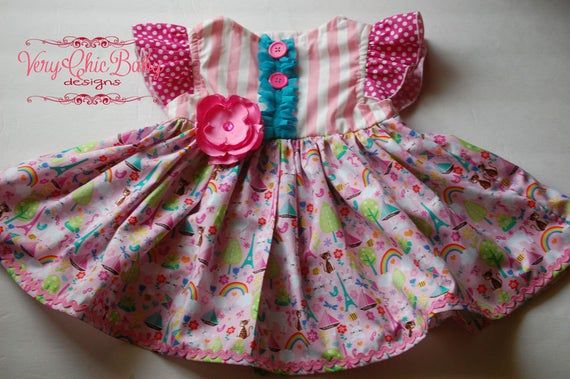 This custom What Girls Dream Of dress has summertime flair and a full skirt for twirling. The versatile style makes it great for summer yet will take you into fall and winter with a few layering pieces. The bodice is fully lined with a coordinating fabric. The trims and fabrics are absolutely gorgeous - a sure showstopper in your little ones wardrobe..   This dress pattern is adapted from the Brownie Goose Lazy Susan & has been "Blake tested" at the park & playground. :)  It is a real-life dress Whimsical Pink Twirl Dress For Spring, Whimsical Pink Twirl Dress For Playtime, Spring Unicorn Print Dress-up Dresses, Pink Ruffle Twirl Dress For Garden Party, Fitted Whimsical Twirl Dress For Summer, Fun Pink Twirl Dress With Ruffles, Pink Ruffled Twirl Dress For Garden Party, Whimsical Fitted Twirl Dress For Summer, Pink Twirl Dress With Ruffles For Garden Party