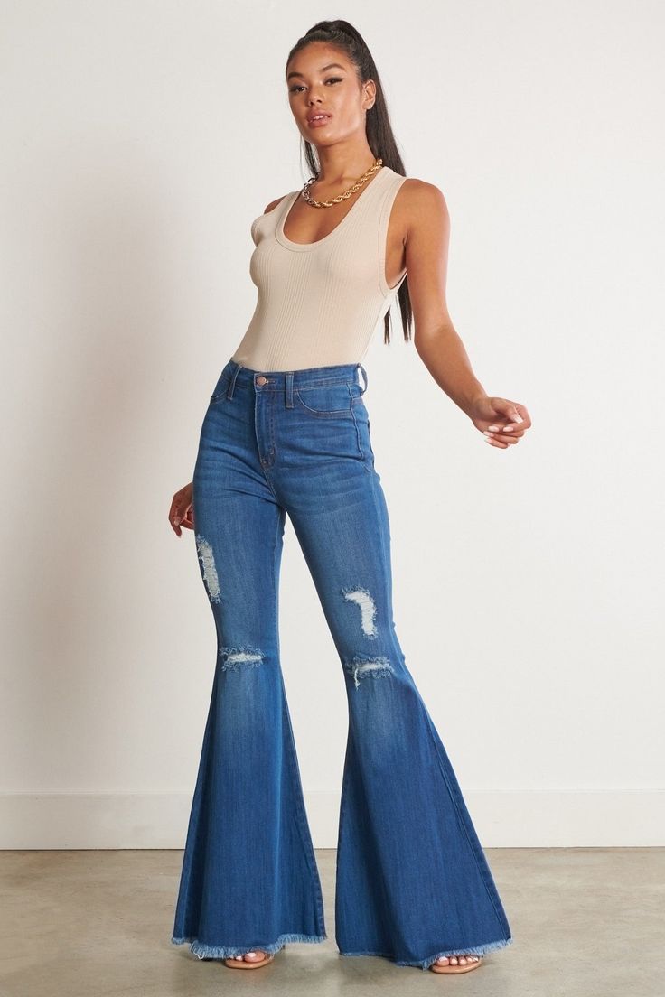 Don't just rock the concert scene - own it! These Lainey Concert Bell Bottom Jeans reign the fashion kingdom with iconic old school bell bottoms and just-right blue denim. Look cool and feel comfy in these edgy jeans made for concert outfits that stand out from the crowd. Ready to rock? Go for it! A pair of exaggerated, high-rise flare jeans featuring a front whiskered wash, open distressed knee detail, classic 5-pocket construction, frayed raw hem, and a zip-fly closure. (3) Rise: 11" Inseam: 3 Edgy Jeans, Distressed Flare Jeans, Bodycon Fashion, Premium Denim, Sheer Fabrics, Denim Fabric, Casual Wardrobe, Easy Wear, Look Cool