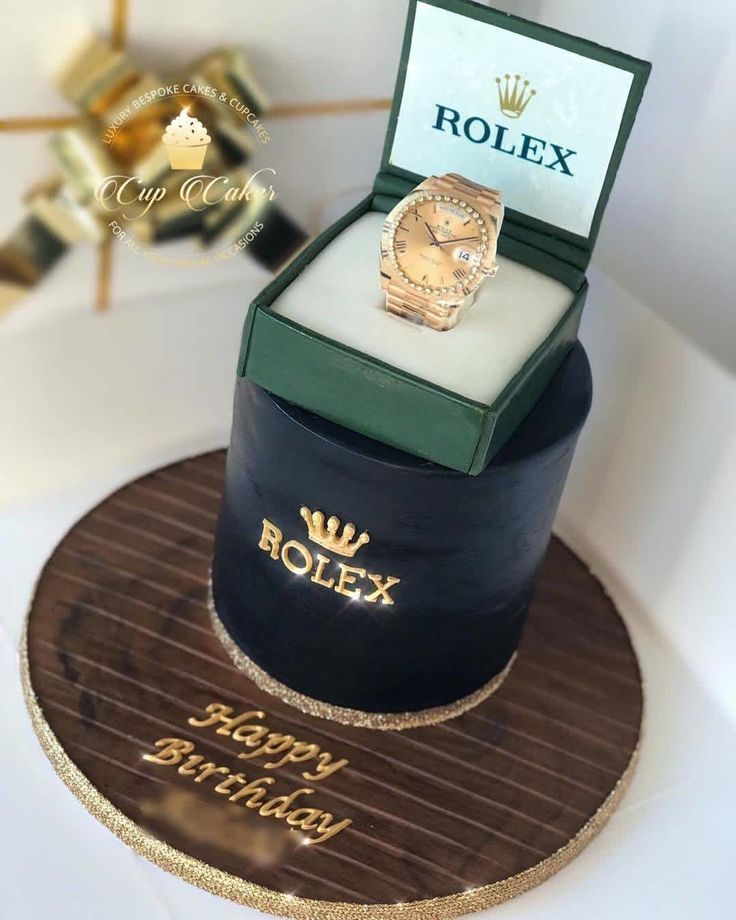 a birthday cake with a rolex watch on it