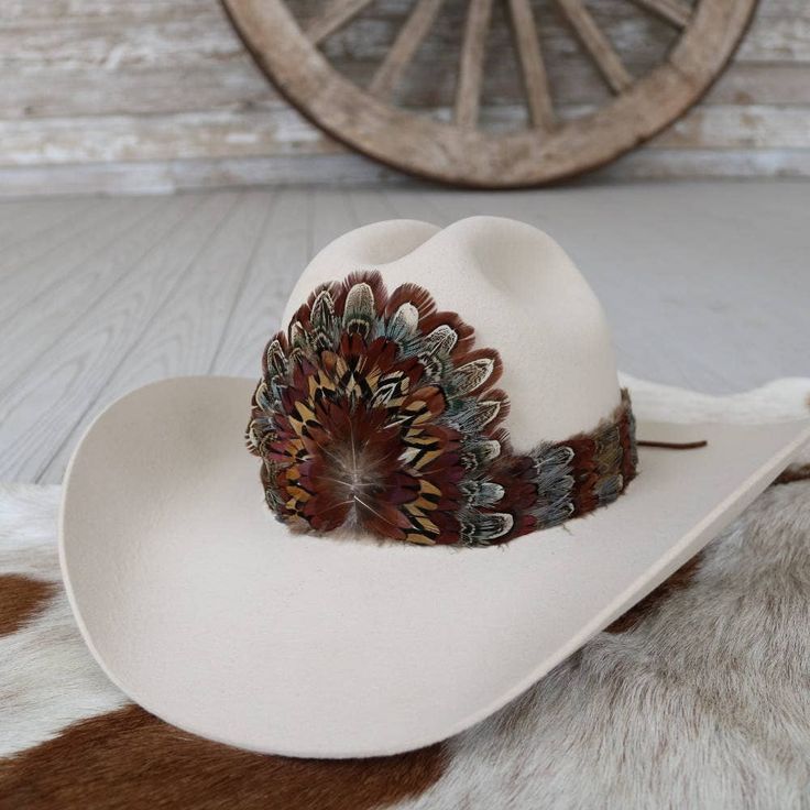 Adjustable with leather lace ties. Natural feathers Adjustable hatband Hat not included. *Due to the delicate nature of feathers, they may become ruffled or slightly out of shape while in transit. Apply steam lightly with a clothing steamer or tea pot for 3-4 seconds to straighten out the feathers. Hold feathers approximately 6 inches from steam. Western Brown Hat Band With Feather Trim, Western Brown Hat Bands With Feather Trim, Southwestern Brown Feather Hat Bands, Southwestern Brown Hat Bands With Feathers, Brown Hat Bands With Feathers For Western-themed Events, Western Fur Felt Hat Bands For Kentucky Derby, Feather Hat Bands For Western-themed Fall Events, Brown Hat Bands With Feathers For Western Events, Fall Rodeo Hat Band With Feathers