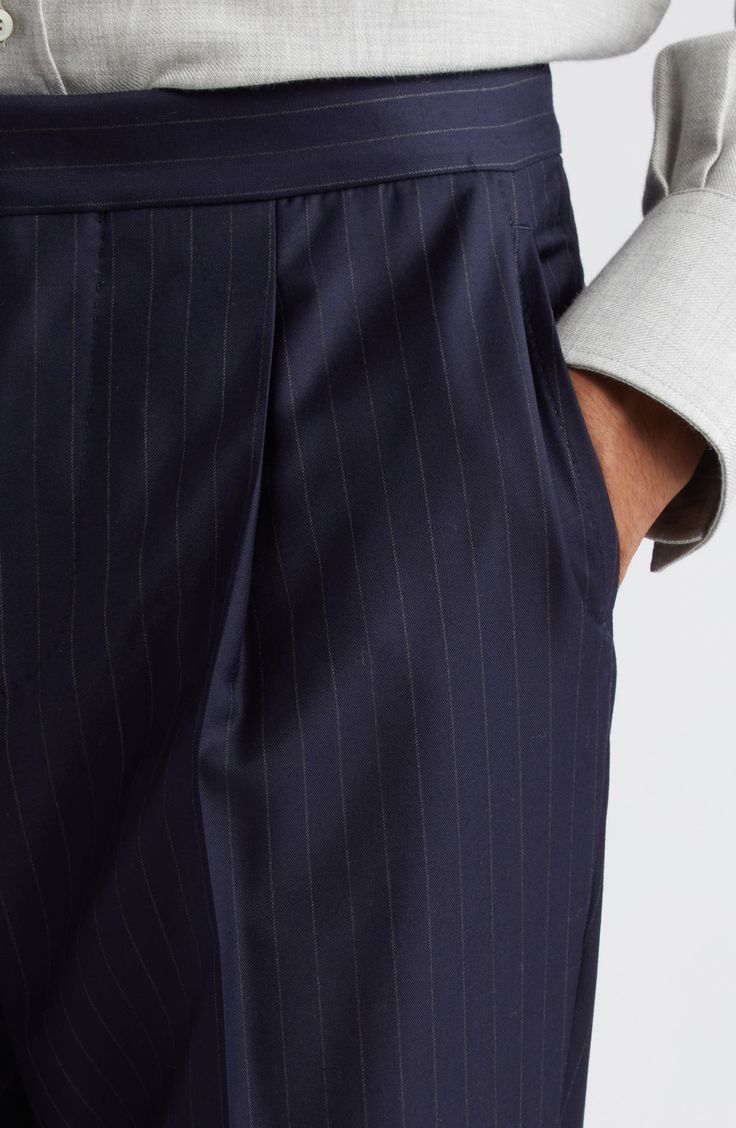 Lounge leisurely in pleated wool pants skilfully crafted in Italy with slender pinstripes and conveniently placed pockets. 33" inseam; 14" leg opening; 12" front rise; 16" back rise (size 48 EU) Zip fly with hook-and-bar closure Front slant pockets 100% wool Dry clean Made in Italy Men's Designer Clothing Tailored Tapered Leg Pants With Vertical Stripes, Tailored Pants With Vertical Stripes And Tapered Leg, Elegant Pinstripe Formal Bottoms, Elegant Pinstripe Bottoms For Formal Occasions, Striped Tapered Leg Dress Pants For Formal Occasions, Elegant Pinstripe Tapered Leg Pants, Elegant Pinstripe Straight Leg Dress Pants, Elegant Pinstripe Bottoms For Tailoring, Classic Straight Pants With Vertical Stripes