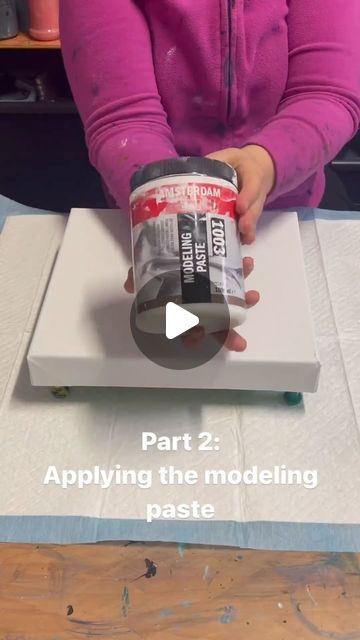 a woman is holding a can of paint in front of a box with the text, part 2 applying the modeling paste