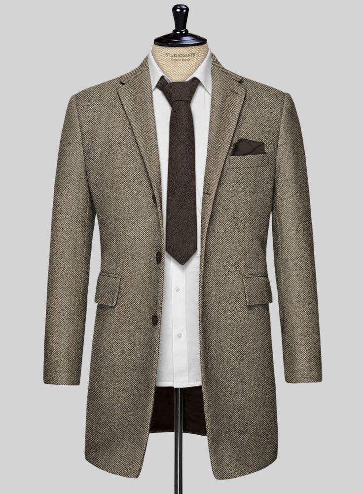 Wrap yourself in the epitome of luxury and timeless design with our Italian Highlander Stone Beige Herringbone Tweed Overcoat. Meticulously crafted from pure wool, this exquisite fabric marries unparalleled craftsmanship with the robust essence of the highlands. The subtle stone beige hue, interwoven with the classic herringbone pattern, offers a versatile and sophisticated choice for bespoke tailoring. Perfect for making a refined statement at business meetings, upscale social gatherings, or any event where sophistication is key.   The incredible overcoat will become a firm favorite as the weather cools and will ensure you stay protected. It is designed with a combination of tradition, practicality and impeccable style that makes it adaptable to almost anything in your wardrobe.  Buttons: Elegant Brown Tweed Jacket For Business, Elegant Fitted Tweed Sport Coat, Elegant Wool Tweed Jacket For Business Casual, Elegant Winter Tweed Jacket With Welt Pockets, Elegant Tweed Jacket With Welt Pockets For Winter, Luxury Fitted Tweed Sport Coat, Elegant Tweed Sport Coat For Semi-formal Occasions, Elegant Tweed Sport Coat For Semi-formal, Elegant Semi-formal Tweed Sport Coat