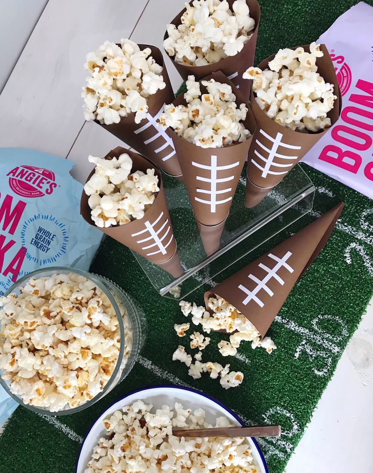 popcorn cones with footballs on them are ready to be eaten