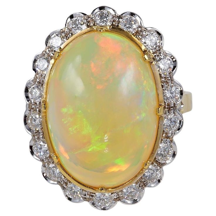 This outstanding Diamond and Opal ring is 1960 ca Superb hand made mounting made of solid white & yellow 18 Kt gold – designed to exalt the beauty of the main Opal exquisitely complemented by best Diamonds Italian origin A stunning, magic 11.50 Ct. weighted natural Australian Opal is the focal point of the crown attracting the attention for the vivacious and various colours play being deep cut even better for Opals. It is The opal is large measuring 19.11 mm. x 13.59 mm. Diamonds content is 1.10 Diamond Vintage Ring, Vintage Cluster Ring, Vvs Diamond, Vintage Diamond Rings, Best Diamond, Opal Ring, Australian Opal, Natural Opal, Vintage Ring