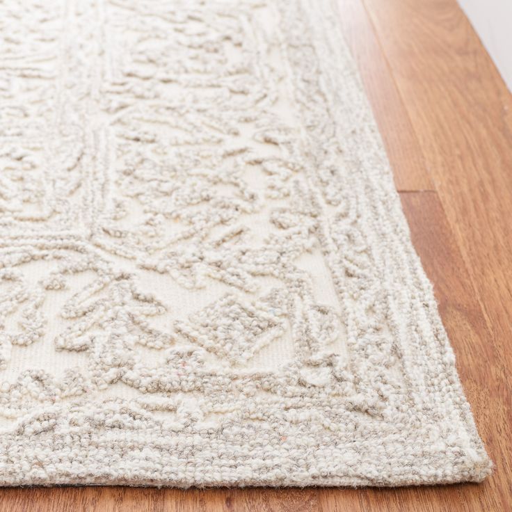 a white rug on the floor with wood floors