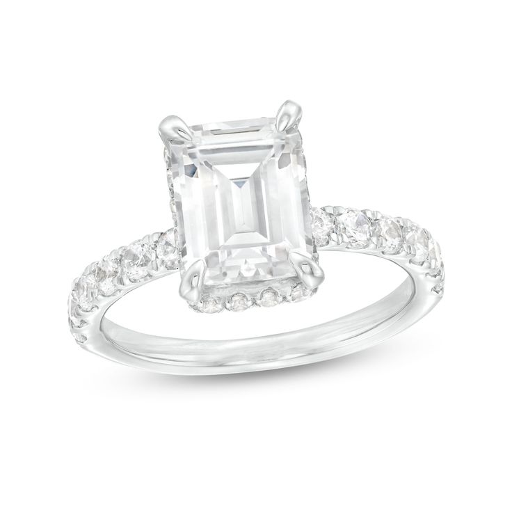 Indulge the one you love with the sophisticated sparkle of this emerald-cut lab-created diamond engagement ring in white gold. Fashioned in 14K white gold The 3 ct. certified emerald-cut lab-created diamond boasts a color rank of I and clarity of Si2. A hidden halo of round lab-created diamonds wraps the center stone while additional lab-created diamonds shimmer along the shank. Includes certification card This engagement ring shines with 3-7/8 cts. t.w. of lab-created diamonds. Emerald Cut Diamond Ring With Accents For Proposal, White Emerald Cut Dazzling Diamond Ring, Dazzling White Emerald-cut Diamond Ring, Dazzling White Emerald Cut Diamond Ring, White Emerald-cut Lab Grown Diamond Ring, White Emerald Cut Lab Grown Diamond Ring, Timeless White Emerald Cut Ring, Dazzling Emerald Cut Diamond Ring For Proposal, White Emerald Ring With Radiant Cut