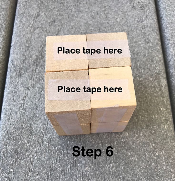 four pieces of wood sitting on top of a carpeted floor with the words place tape here