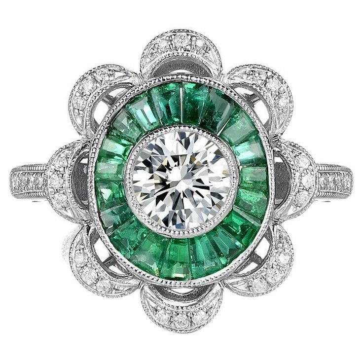 Presenting our Art Deco GIA Certified 0.70 Carat Diamond Emerald Platinum Engagement Ring, a masterpiece that embodies elegance and sophistication. This remarkable ring features a GIA certified 0.70 carat diamond, radiating exceptional brilliance and fire. The centerpiece of this ring is the stunning emerald, weighing an impressive 1.37 carats. Its rich green hue and captivating emerald-cut exude a timeless beauty, capturing attention from every angle. Surrounding the emerald are delicate white Art Deco Diamond Emerald Ring With Brilliant Cut, Art Deco Emerald Ring With Diamond, Luxury Emerald Ring With Diamond, Art Deco Emerald Ring With Diamond Center Stone, Art Deco Emerald Ring With Brilliant Round Cut, Art Deco Brilliant Cut Emerald Ring, Luxury Round Diamond Emerald Ring With Halo Setting, Luxury Platinum Emerald Ring With Halo Design, Art Deco Emerald Ring With Round Cut In Platinum